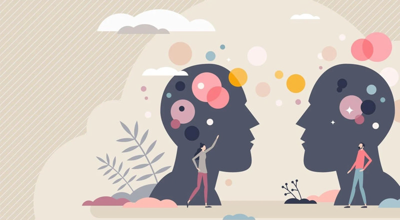 کارتونی از دو سر بزرگ و دو نفر جلوی آن