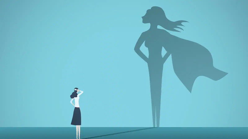 کارتونی از زنی که سایه‌اش بر روی دیوار تصویر یک سوپرومن را شکل داده است و نشان از اعتماد به نفس دارد