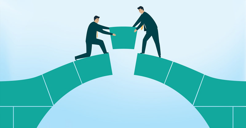 کارتونی از دو مرد در حال ساختن پل با یکدیگر